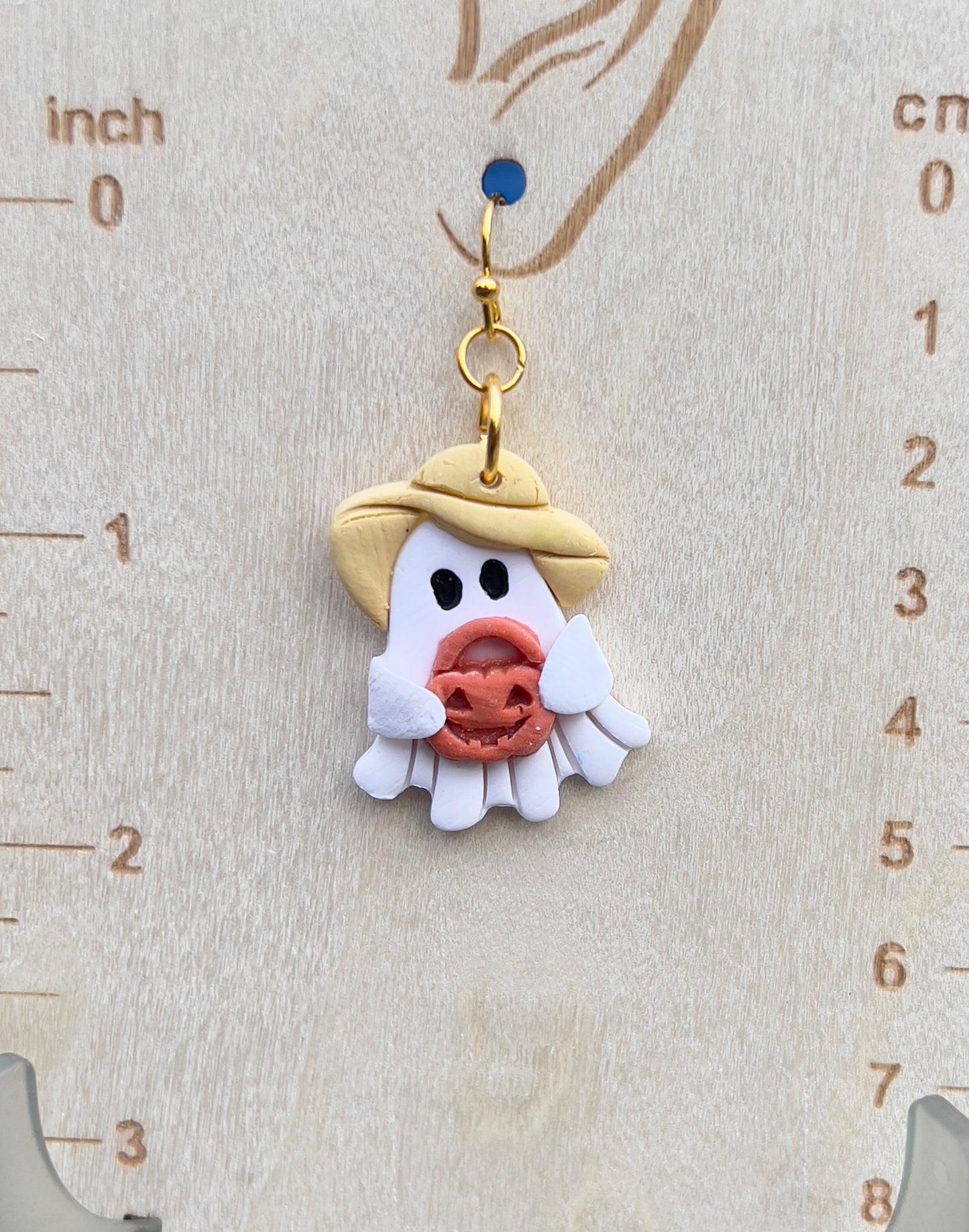 Ghost wearing a sun hat holding jack-o’-lantern lightweight clay earrings